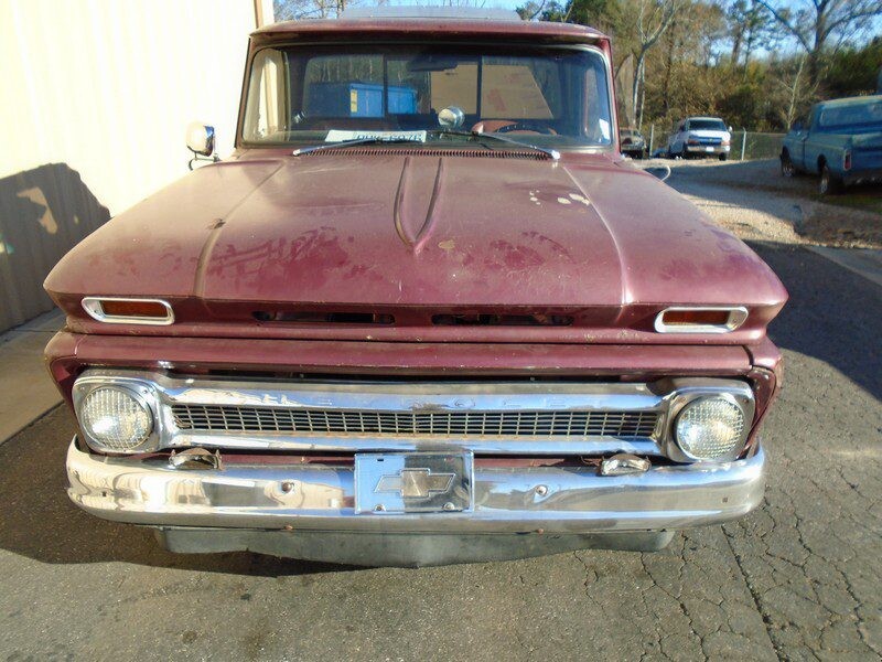 Vintage maroon Chevrolet C10 pickup truck.