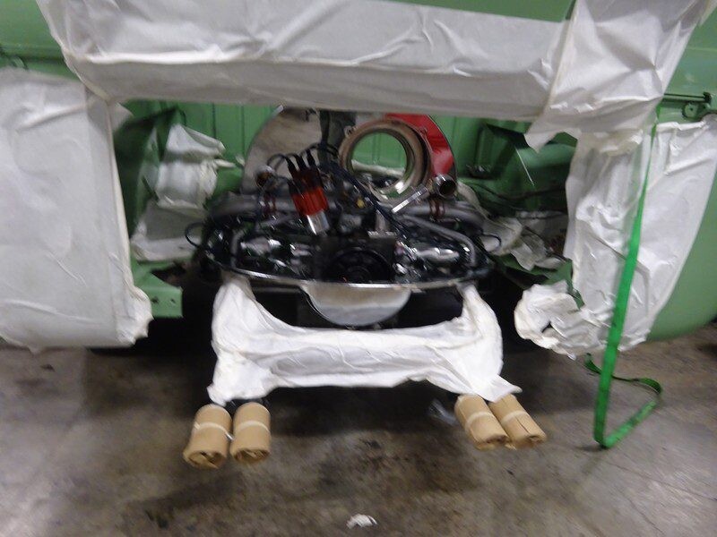 Car engine under protective covering.