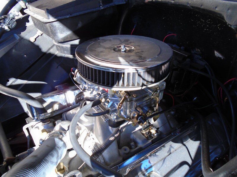 Vintage car engine with air filter.