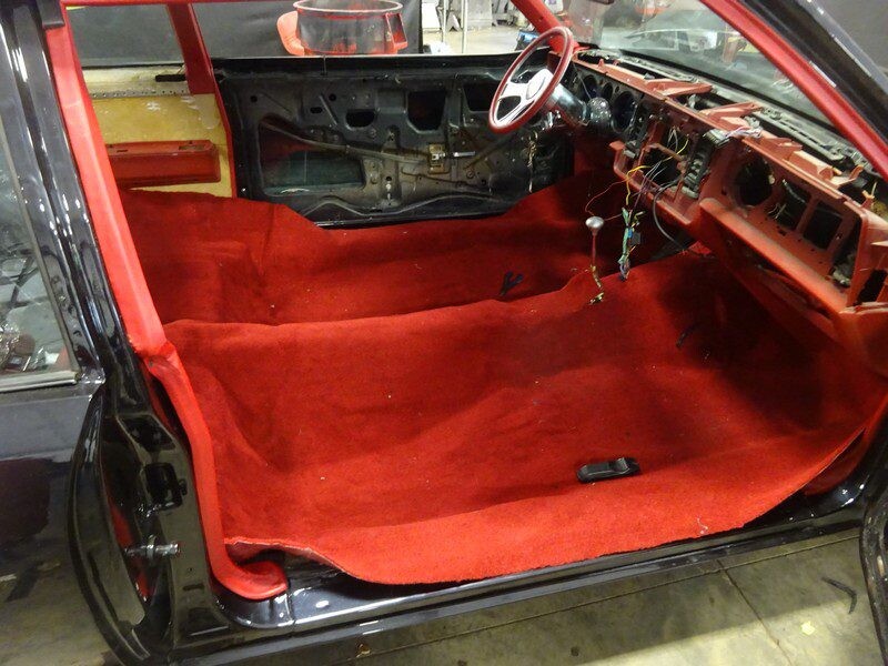 Red carpet interior of a classic car.
