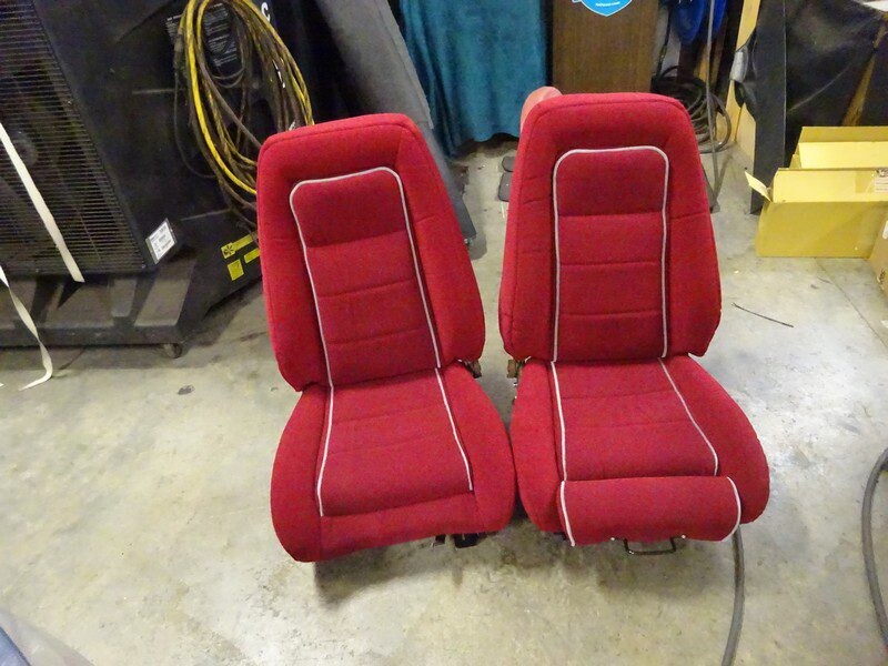 Red car seats with white piping.