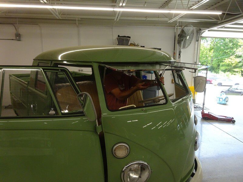 Green VW bus window installation.