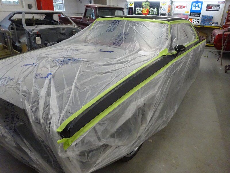 Car covered in plastic wrap for paint.