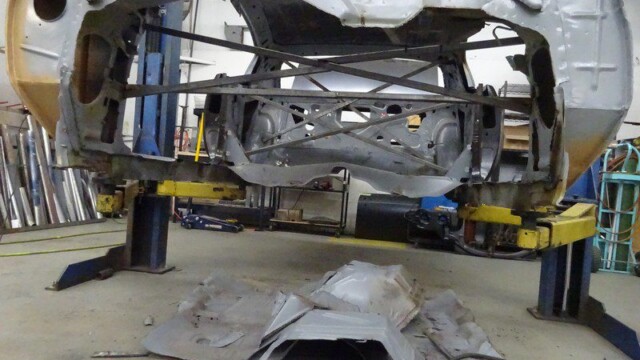 Car body undergoing restoration work.
