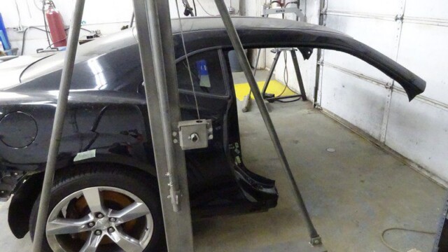 Black Camaro body in auto repair.
