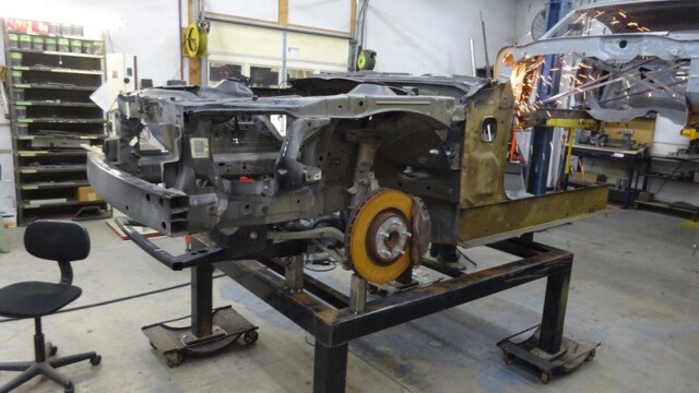 Car body undergoing repair in a shop.