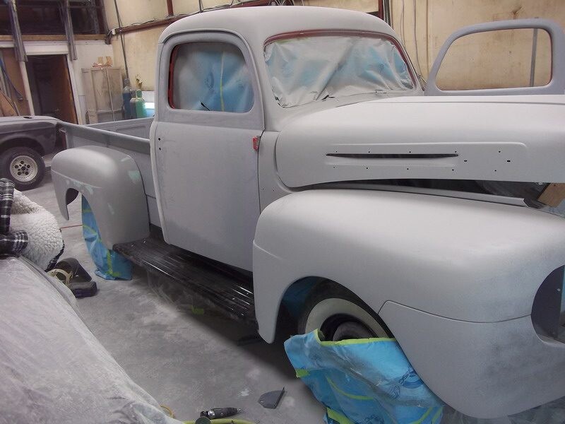 Primered vintage Ford pickup truck restoration.