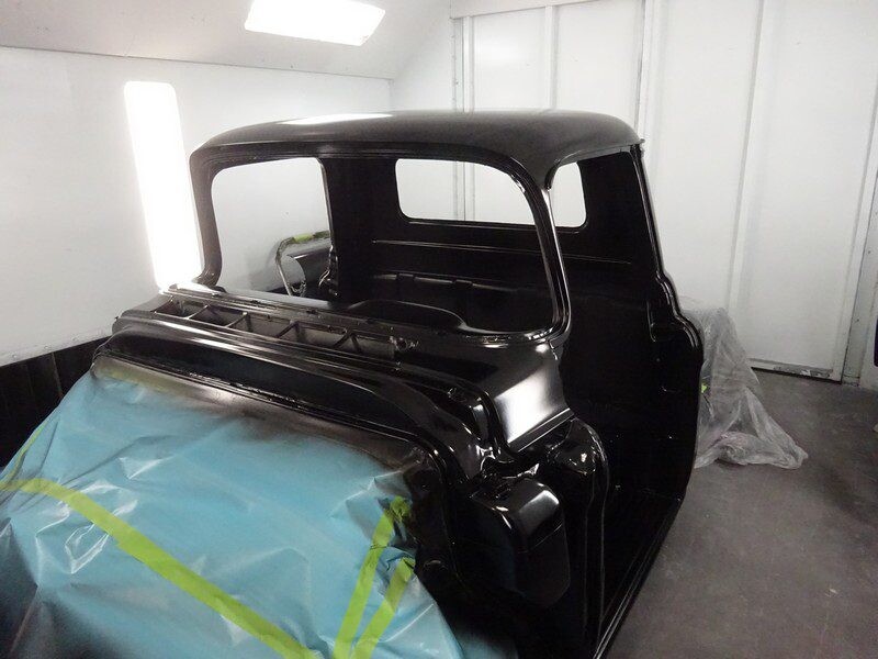 Black classic truck cab, freshly painted.