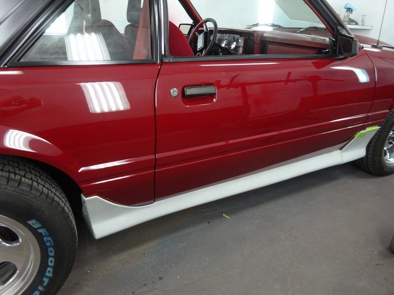 Red Ford Mustang side profile.
