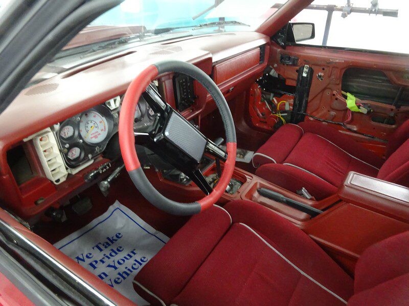 Red interior of a classic Mustang.