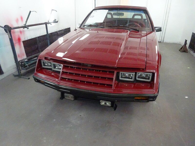 Red Ford Mustang in auto shop.