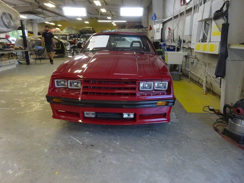 Red Ford Mustang in auto shop.
