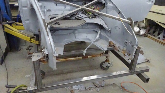 Car body shell on repair stand.