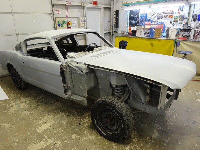 Restoration project Mustang coupe primed in garage