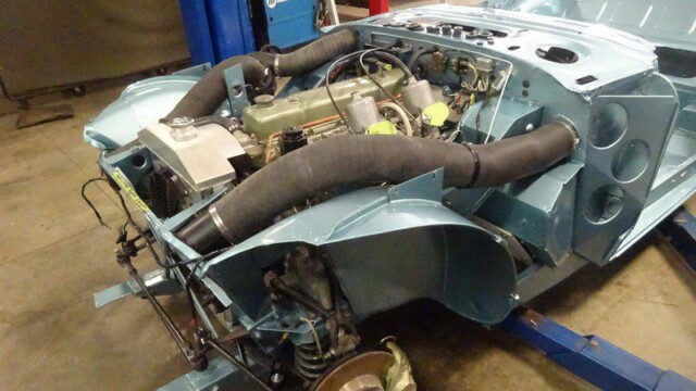 Light blue classic car engine bay.