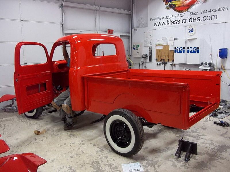 Red classic truck in auto shop.