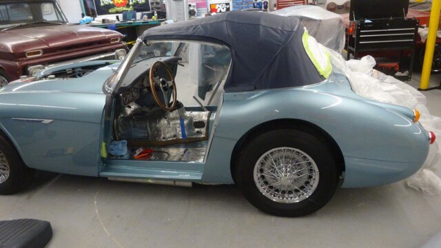 Light blue classic car in auto shop.