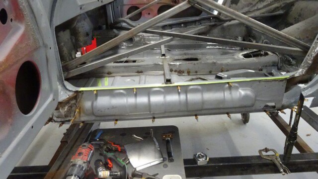 Car restoration: floor panel repair in progress.