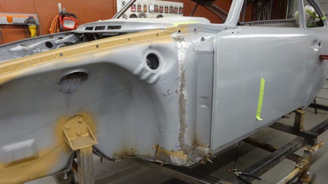 Primed front body tub on rotisserie stand