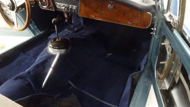 Classic car interior, blue carpet.