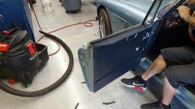 Classic car door panel repair in progress.