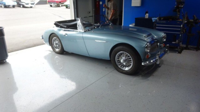 Light blue Austin Healey in garage.