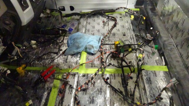 Car interior wiring installation in progress.