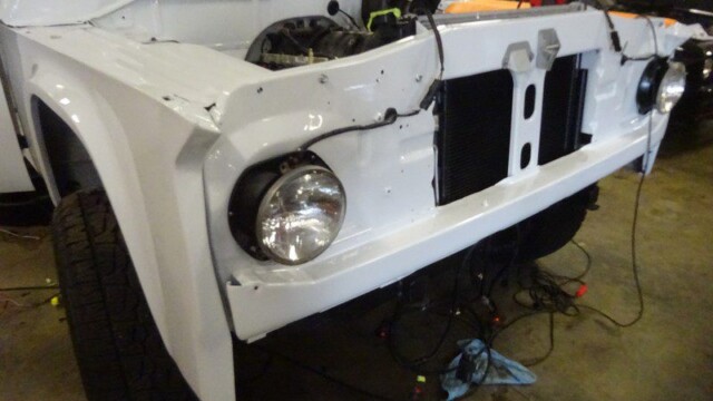 White vintage truck front end under repair.