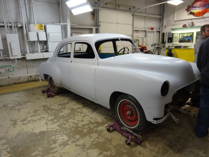White classic car in auto shop.