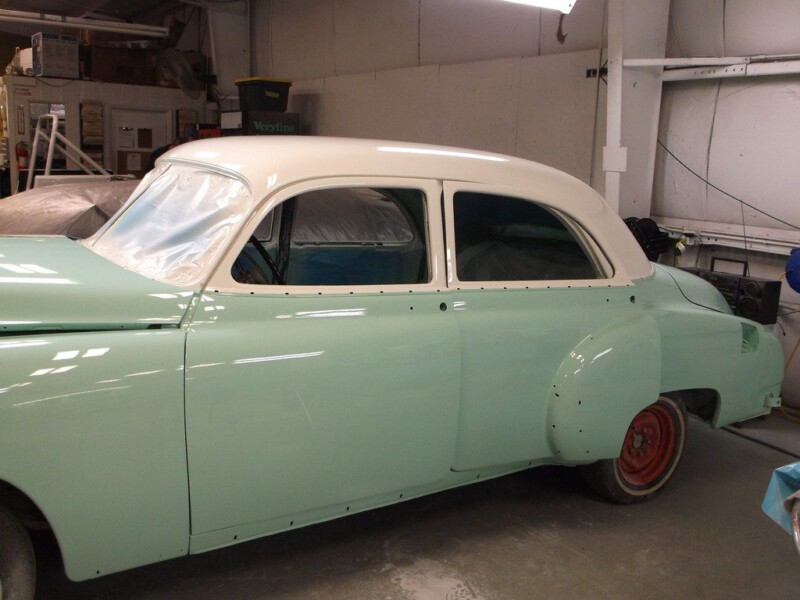 Mint green vintage car, bodywork in progress.
