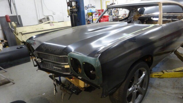 Black Chevy Malibu under restoration.