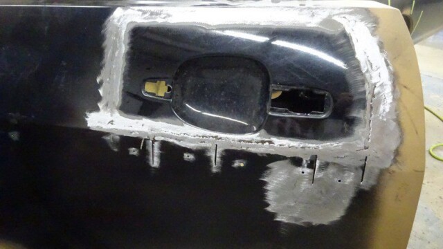 Car door panel repair in progress.