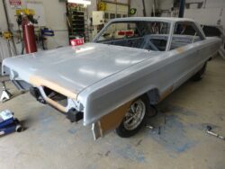 Gray classic car body in progress.
