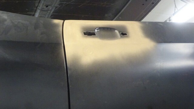 Car door, primered, bodywork in progress.