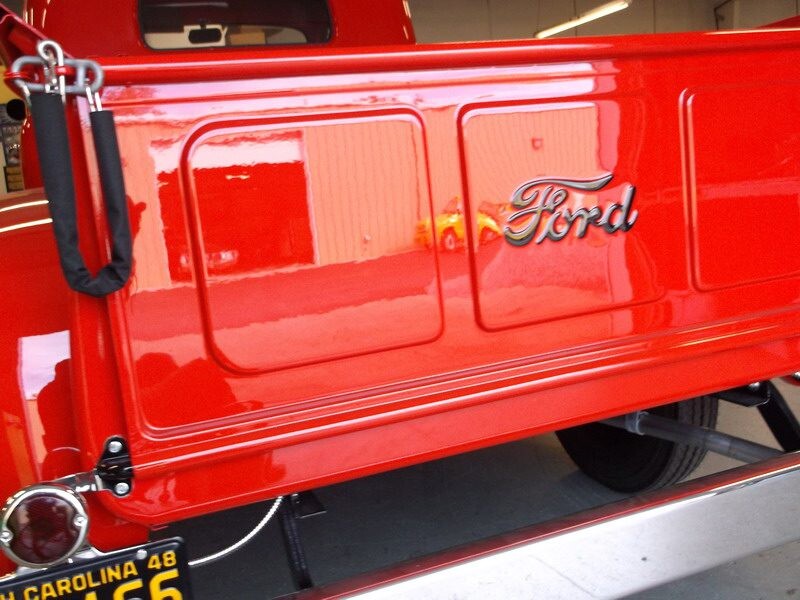 Red Ford truck tailgate, classic car.