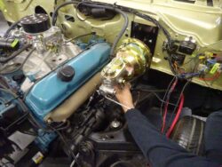 Mechanic installing a car's brake booster.