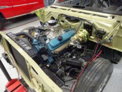 Partially installed teal V8 engine and components