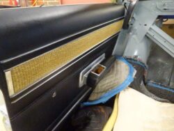 Black door panel with woven gold trim