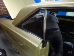 Person working on a classic car's interior.