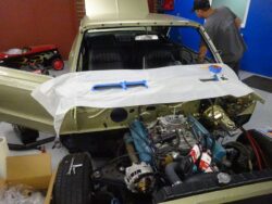 Partially installed V8 engine in classic car