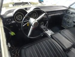 Classic car interior, dashboard, and steering wheel.