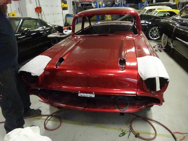 Red classic car in auto shop restoration.