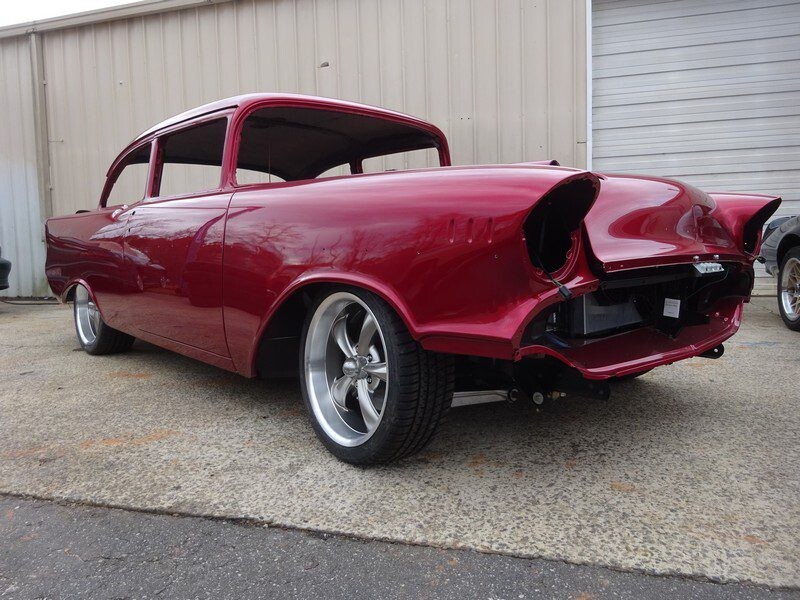 Red classic car under restoration.