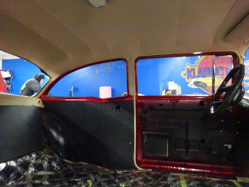 Red classic car interior under construction.