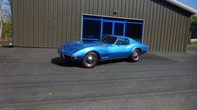 Blue Corvette parked by garage.