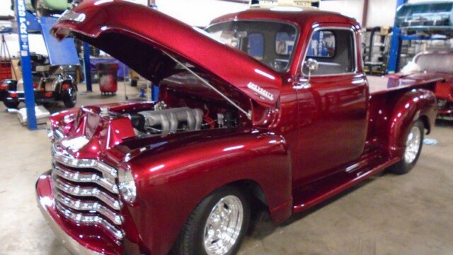 Red classic Chevrolet pickup truck.