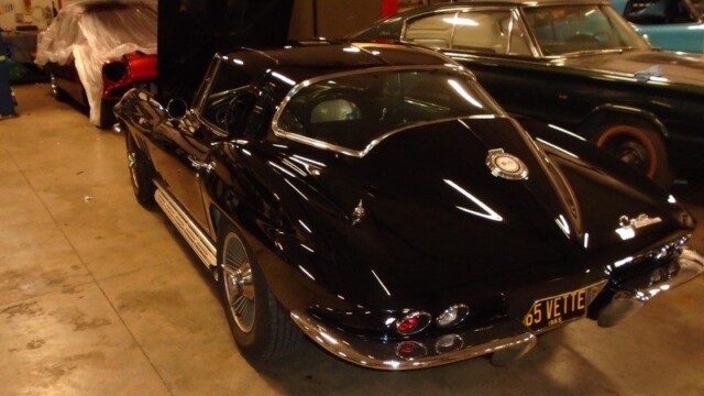 Black 1965 Corvette in garage.