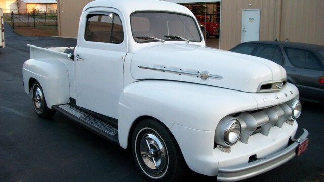 White vintage Ford pickup truck.