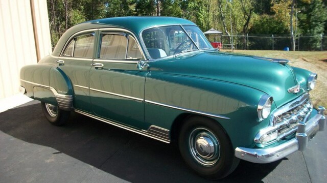 Green 1950 Chevrolet Deluxe sedan.