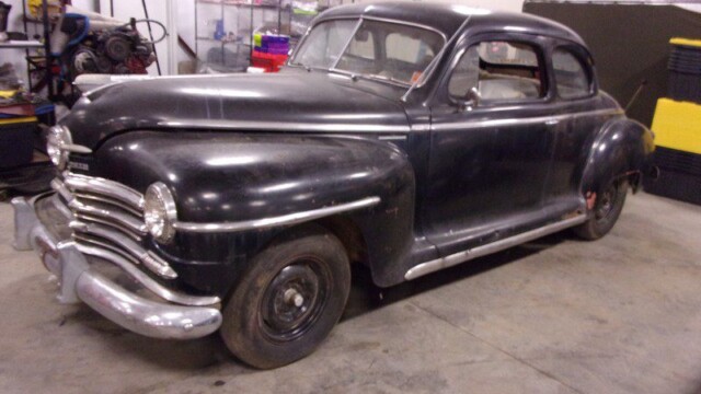 Black 1947 Plymouth coupe, restoration project.
